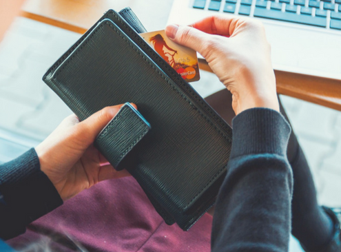 Woman uses credit card to pay for Impressions invisible aligners