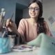 Women takes up painting as she straightens her teeth at home with invisible aligners