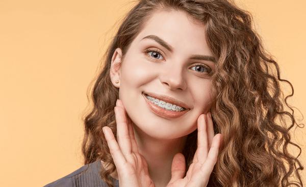 Woman wearing braces to straighten teeth